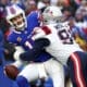 Buffalo Bills quarterback Josh Allen, left, is sacked by New England Patriots defensive end Deatrich Wise Jr. (91) during the first half of an NFL football game in Orchard Park, N.Y., Sunday, Dec. 31, 2023. Wise was the highest ranked PFF player for the Patriots in the game. (AP Photo/Jeffrey T. Barnes )
