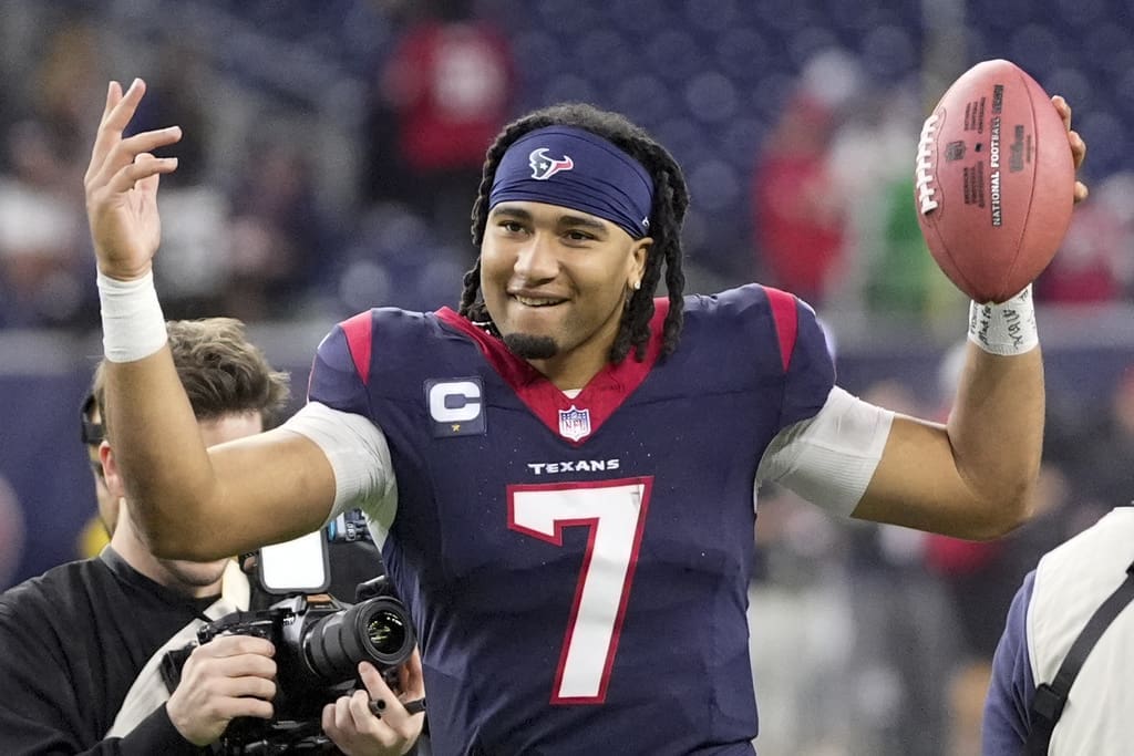 While the New England Patriots watch from home, Houston Texans quarterback C.J. Stroud celebrates after their win against the Cleveland Browns in an NFL wild-card playoff football game Saturday, Jan. 13, 2024, in Houston. (AP Photo/David J. Phillip)