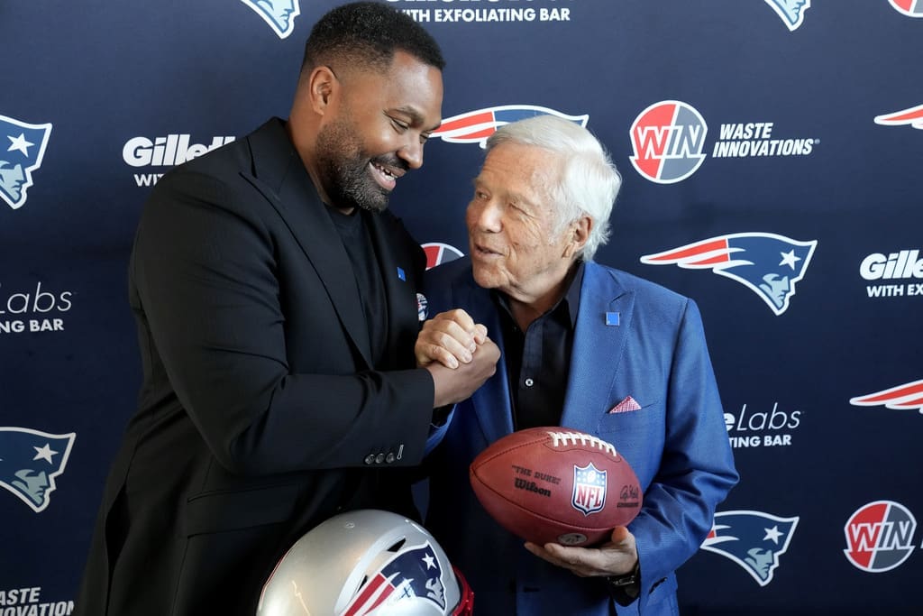 Newly-named New England Patriots head coach Jerod Mayo, left, and Patriots owner Robert Kraft shake hands Wednesday, Jan. 17, 2024, following an NFL football news conference, in Foxborough, Mass. Mayo succeeds Bill Belichick as the franchise's 15th head coach. (AP Photo/Steven Senne)