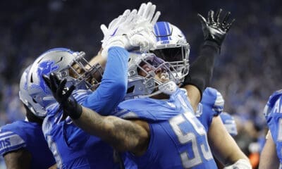 Detroit Lions linebacker Derrick Barnes (55) receives congratulations from teammates after he makes an interception in the fourth quarter against the Tampa Bay Buccaneers during an NFL divisional round playoff football game Sunday, Jan. 21, 2024, in Detroit. (AP Photo/Rick Osentoski)