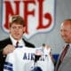 Pete Rozelle, NFL commissioner, right, began the 54th annual draft of collegiate talent. His final draft, by announcing the selection of UCLA quarterback Troy Aikman left, as the first pick of the NFL Draft by the Dallas Cowboys on Sunday, April 23, 1989 in New York. Aikman already has signed a six-year, $11.2 million contract wih the Cowboys.(AP Photo/Mark Lennihan)