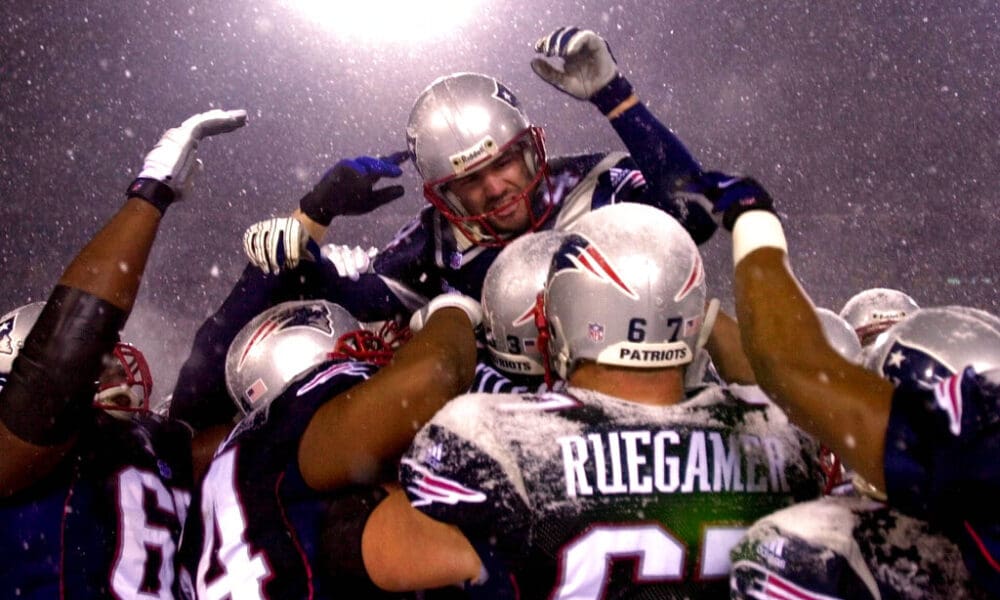 New England Patriots kicker Adam Vinatieri, top, is hoisted to the shoulders of his teammates after his game-winning overtime field goal against the Oakland Raiders in the AFC Divisional Playoff game at Foxboro Stadium, in Foxboro, Mass., Saturday Jan. 19, 2002. The Patriots won 16-13. (AP Photo/Charles Krupa)