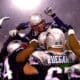 New England Patriots kicker Adam Vinatieri, top, is hoisted to the shoulders of his teammates after his game-winning overtime field goal against the Oakland Raiders in the AFC Divisional Playoff game at Foxboro Stadium, in Foxboro, Mass., Saturday Jan. 19, 2002. The Patriots won 16-13. (AP Photo/Charles Krupa)