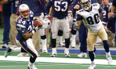 New England Patriots cornerback Ty Law (24) intercepts a pass from St. Louis Rams quarterback Kurt Warner as intended receiver Isaac Bruce (80) looks on during Super Bowl XXXVI, Sunday, Feb. 3, 2002, in New Orleans. (AP Photo/Kathy Willens)