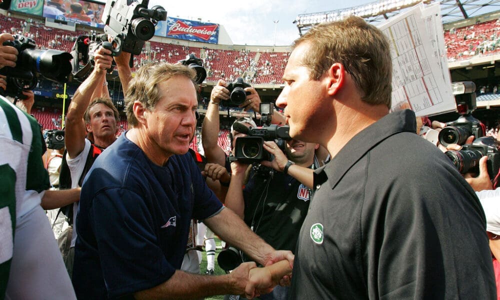 FILE - In this Sept. 9, 2007, file photo, New England Patriots' head coach Bill Belichick, left, shakes hands with New York Jets' head coach Eric Mangini after their NFL football game in East Rutherford, N.J. Once close friends, Mangini and Belichick had a falling out, a rift that included Mangini leaving Belichick's staff to coach in New York and the infamous "Spygate" affair when Mangini accused the Patriots of videotaping the Jets' defensive signals during the 2007 season opener. The two will renew their rivalry on Sunday when the Cleveland Browns host the Patriots this weekend. (AP Photo/Mel Evans, File)