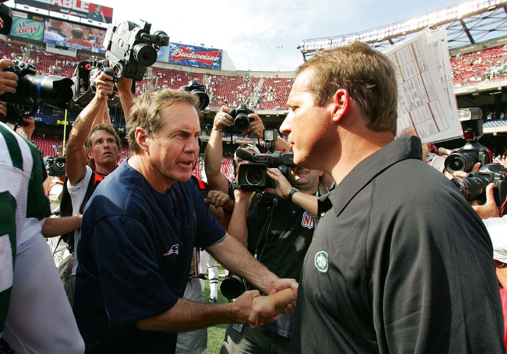 FILE - In this Sept. 9, 2007, file photo, New England Patriots' head coach Bill Belichick, left, shakes hands with New York Jets' head coach Eric Mangini after their NFL football game in East Rutherford, N.J. Once close friends, Mangini and Belichick had a falling out, a rift that included Mangini leaving Belichick's staff to coach in New York and the infamous "Spygate" affair when Mangini accused the Patriots of videotaping the Jets' defensive signals during the 2007 season opener. The two will renew their rivalry on Sunday when the Cleveland Browns host the Patriots this weekend. (AP Photo/Mel Evans, File)
