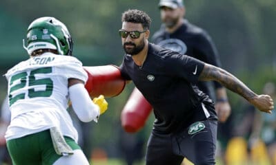 New York Jets running backs coach Taylor Embree takes part in drills with running back Ty Johnson (25) during the NFL football team's training camp in Florham Park, N.J., Thursday, July 28, 2022. (AP Photo/Adam Hunger)