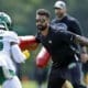 New York Jets running backs coach Taylor Embree takes part in drills with running back Ty Johnson (25) during the NFL football team's training camp in Florham Park, N.J., Thursday, July 28, 2022. (AP Photo/Adam Hunger)