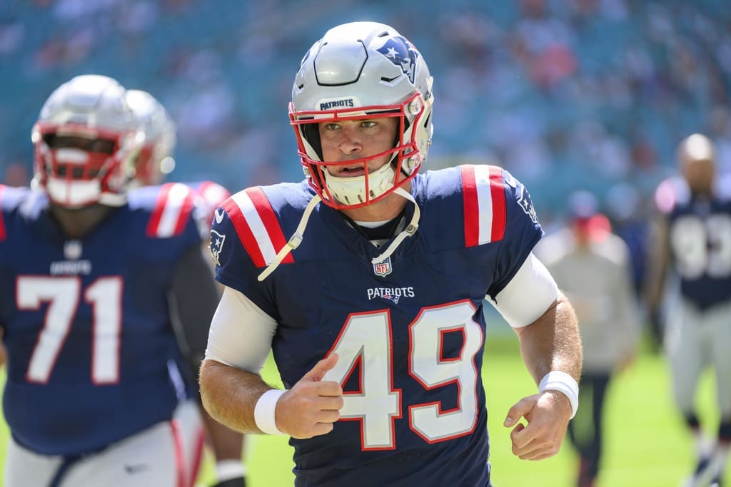 New England Patriots long snapper Joe Cardona (49) runs on the field before the start of an NFL football game against the Miami Dolphins, Sunday, Oct. 29, 2023, in Miami Gardens, Fla. (AP Photo/Doug Murray)
