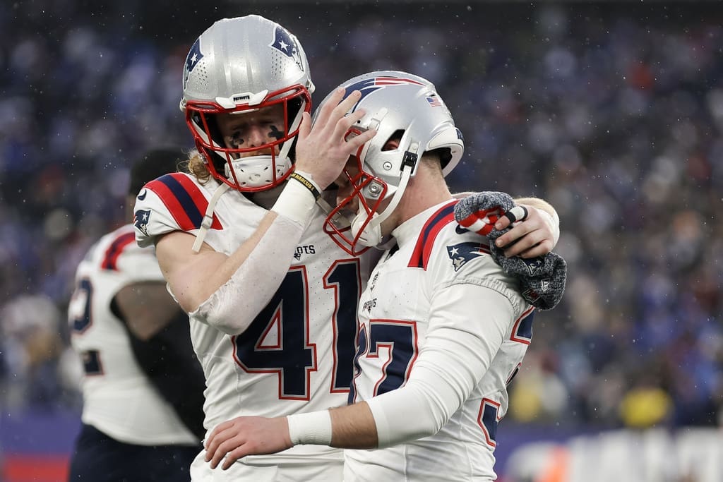 New England Patriots safety Brenden Schooler (41) talks with New England Patriots place kicker Chad Ryland (37) after Ryland missed a field goal with seconds remaining on the clockduring the fourth quarter of an NFL football game against the New York Giants, Sunday, Nov. 26, 2023, in East Rutherford, N.J. Can new Patriots special teams coordinator Jeremy Springer help turn this unit around in 2024? (AP Photo/Adam Hunger)