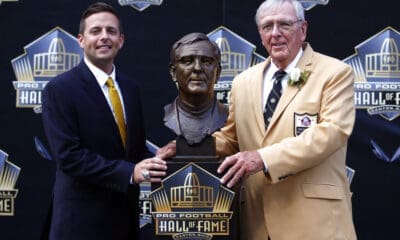 Former NFL contributor Ron Wolf, right, poses with a bust of himself and presenter, son, Eliot Wolf, during an induction ceremony at the Pro Football Hall of Fame, Saturday, Aug. 8, 2015 in Canton, Ohio. (AP Photo/Gene J. Puskar)