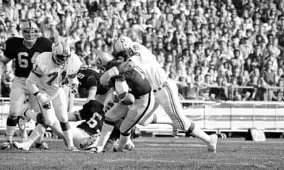 Quarterback Ken Stabler of the Oakland Raiders is sacked behind the lines by Julius Adams (85) of the New England Patriots in the first period of National Football League Playoff Game on Saturday, Dec. 18, 1976 in Oakland. Moving in at left is Ray Hamilton of the Patriots. (AP Photo)