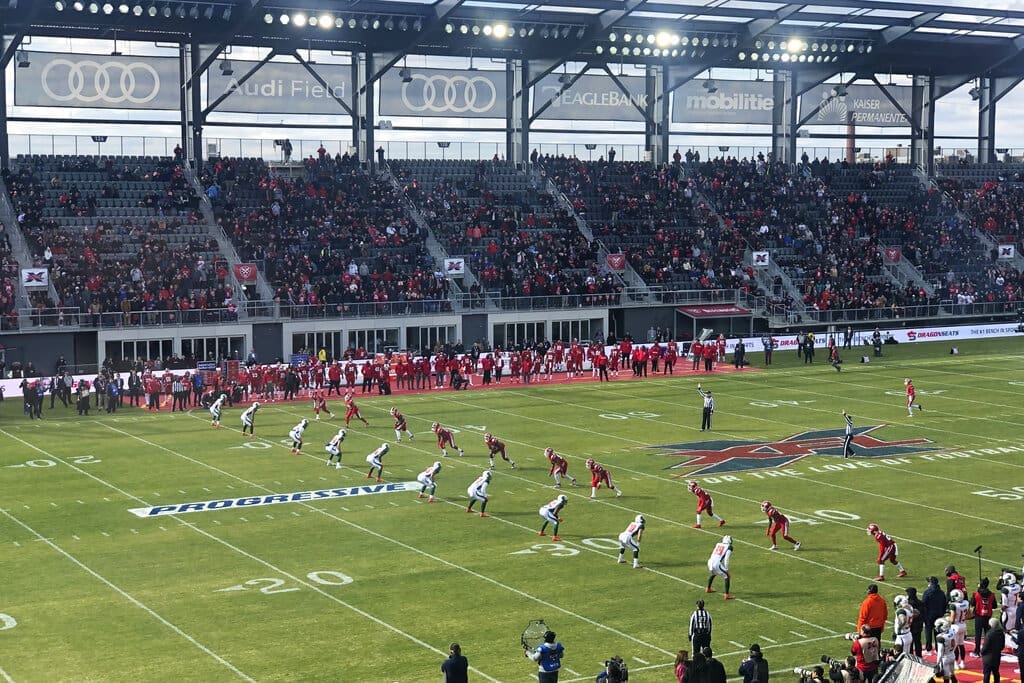 The D.C. Defenders, right, line up against the Seattle Dragons for the opening kickoff of the opening football game of the XFL season, Saturday, Feb. 8, 2020, in Washington, DC. The NFL is implementing the XFL kickoff rules for the 2024 NFL season. (AP Photo/Stephen Whyno)