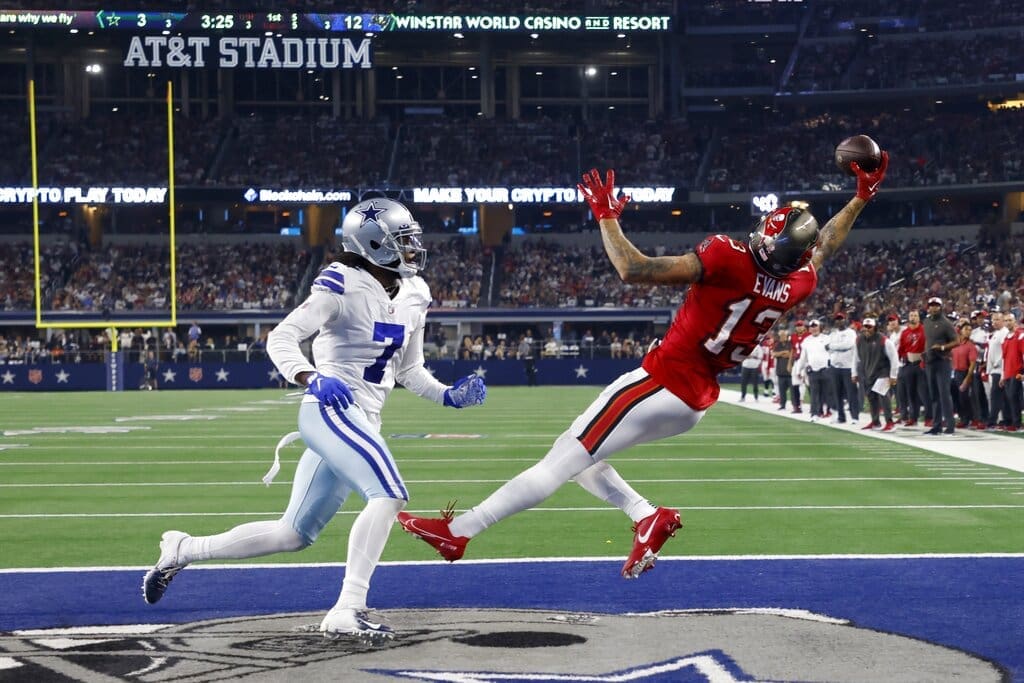 Tampa Bay Buccaneers wide receiver Mike Evans (13) catches a touchdown pass as Dallas Cowboys cornerback Trevon Diggs (7) defends in the second half of a NFL football game in Arlington, Texas, Sunday, Sept. 11, 2022. Evans has resigned with the Buccaneers giving the New England Patriots one less wide receiver option in free agency (AP Photo/Michael Ainsworth)