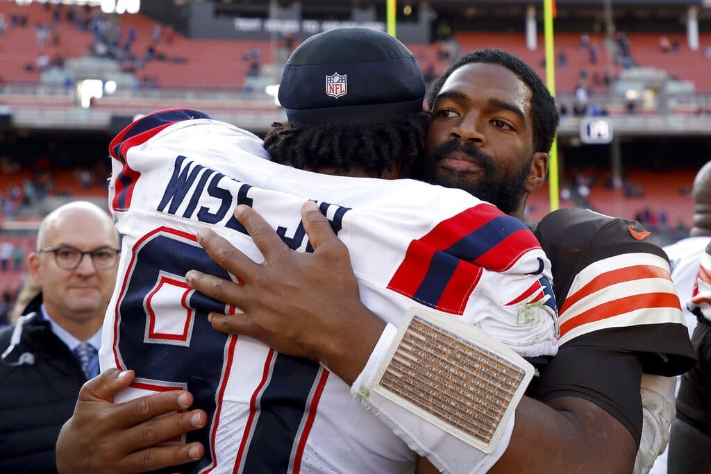 Cleveland Browns quarterback Jacoby Brissett (7) hugs New England Patriots defensive end Deatrich Wise Jr. (91) after an NFL football game, Sunday, Oct. 16, 2022, in Cleveland. (AP Photo/Kirk Irwin)