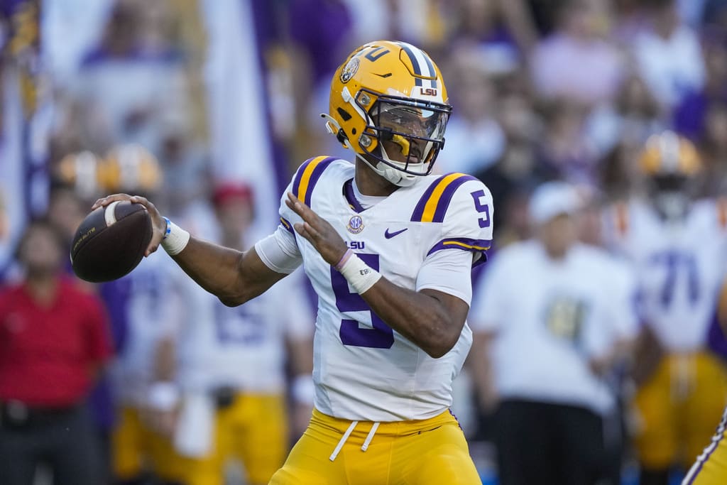 LSU QB Jayden Daniels (5) drops back to pass in the first half of an NCAA college football game against Auburn in Baton Rouge, La., Saturday, Oct. 14, 2023. (AP Photo/Gerald Herbert)