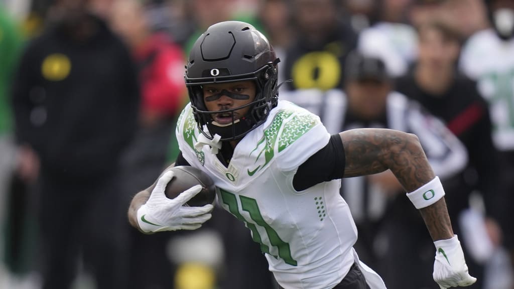 New England Patriots NFL Draft target,Oregon wide receiver Troy Franklin (11) carries the ball during the first half of an NCAA college football game against Utah Saturday, Oct. 28, 2023, in Salt Lake City. (AP Photo/Rick Bowmer)