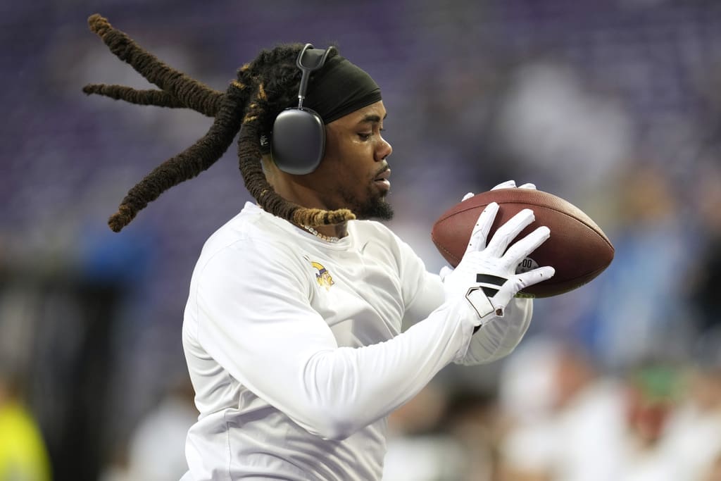 Minnesota Vikings wide receiver K.J. Osborn warms up before an NFL football game against the Detroit Lions, Sunday, Dec. 24, 2023, in Minneapolis. (AP Photo/Abbie Parr)