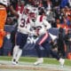 New England Patriots safety Cody Davis (22) scores a touchdown against the Denver Broncos of an NFL football game Sunday December 24, 2023, in Denver. (AP Photo/Bart Young)