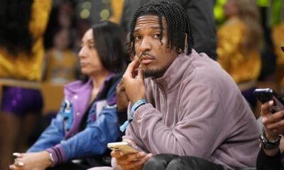 Potential New England Patriots draft pick and Heisman Memorial Trophy winner, Louisiana State quarterback Jayden Daniels, watches during the second half of an NBA basketball game between the Los Angeles Lakers and the Miami Heat Wednesday, Jan. 3, 2024, in Los Angeles. (AP Photo/Mark J. Terrill)