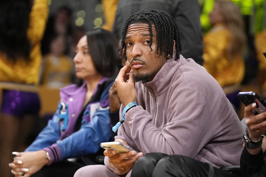 Potential New England Patriots draft pick and Heisman Memorial Trophy winner, Louisiana State quarterback Jayden Daniels, watches during the second half of an NBA basketball game between the Los Angeles Lakers and the Miami Heat Wednesday, Jan. 3, 2024, in Los Angeles. (AP Photo/Mark J. Terrill)