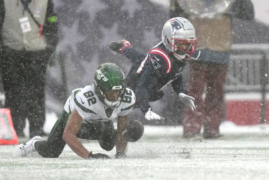 New York Jets wide receiver Xavier Gipson (82) and New England Patriots cornerback Marco Wilson (19) pursue the ball during the first half of an NFL football game, Sunday, Jan. 7, 2024, in Foxborough, Mass. (AP Photo/Steven Senne)