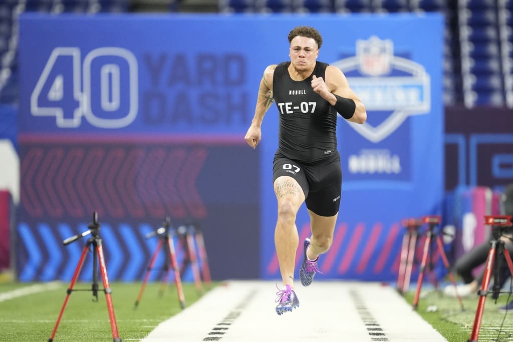 New England Patriots draft prospect, Penn State tight end Theo Johnson runs the 40-yard dash at the NFL football scouting combine, Friday, March 1, 2024, in Indianapolis. Johnson is one of the top tight ends available in the 2024 NFL Draft. (AP Photo/Michael Conroy)