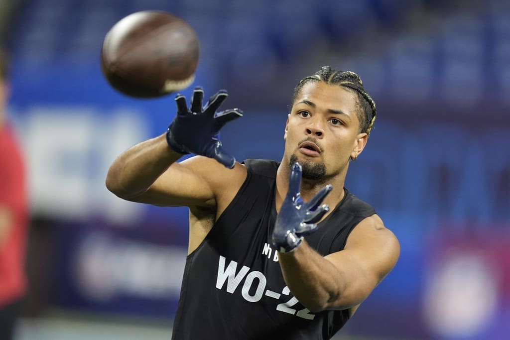 NFL Draft prospect, Washington wide receiver Rome Odunze runs a drill at the NFL football scouting combine, Saturday, March 2, 2024, in Indianapolis. (AP Photo/Michael Conroy)