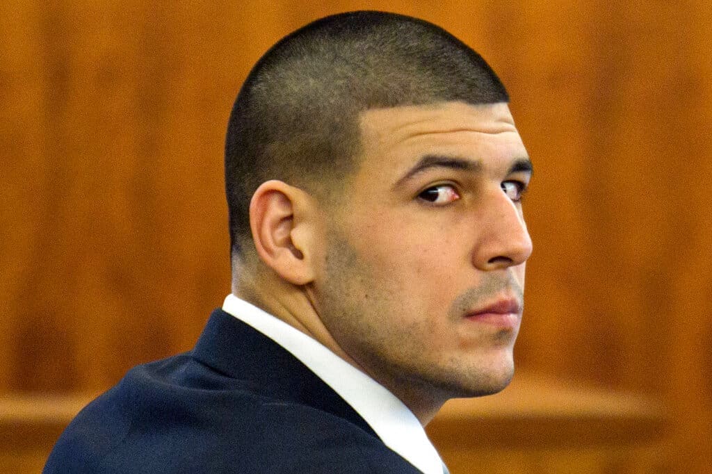 Former NFL player Aaron Hernandez of the New England Patriots listens during his murder trial at the Bristol County Superior Court in Fall River, Mass., Wednesday, Feb. 18, 2015. Hernandez is accused in the June 17, 2013, killing of Odin Lloyd, who was dating his fiancée's sister. (AP Photo/Dominick Reuter, Pool)