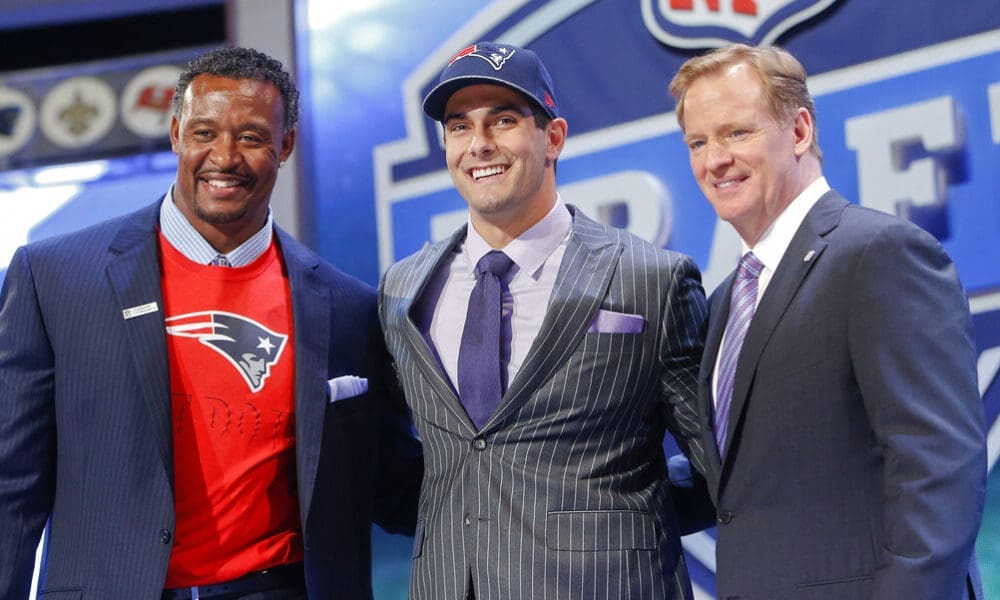 Eastern Illinois quarterback Jimmy Garoppolo poses for photos with NFL commissioner Roger Goodell and former New England Patriots linebacker Willie McGinest after being selected as the 62nd pick by the New England Patriots in the second round of the 2014 NFL Draft, Friday, May 9, 2014, in New York. (AP Photo/Jason DeCrow)