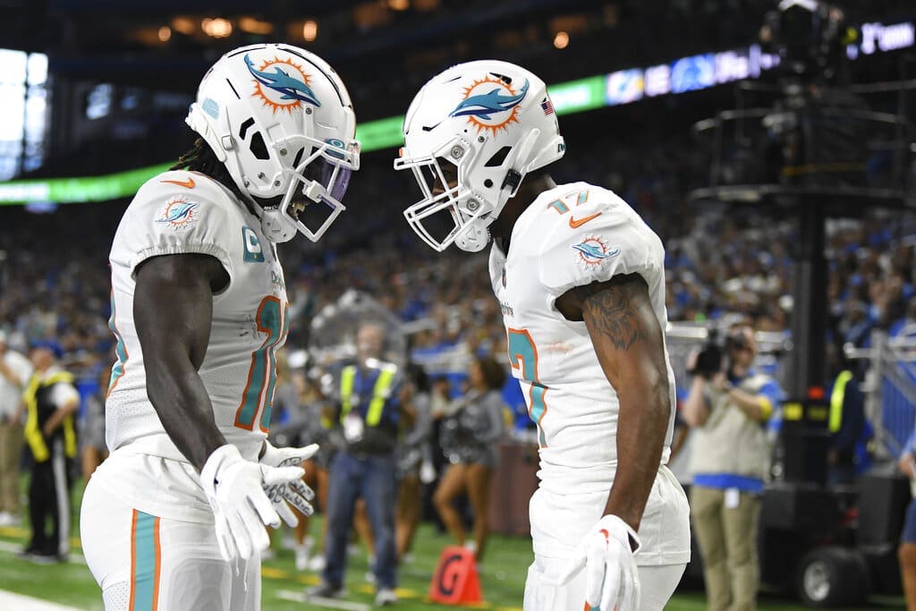 New England Patriots rivals, Miami Dolphins wide receiver Jaylen Waddle, right, greets wide receiver Tyreek Hill after catching a 5-yard pass for a touchdown during the first half of an NFL football game against the Detroit Lions, Sunday, Oct. 30, 2022, in Detroit. (AP Photo/Lon Horwedel)