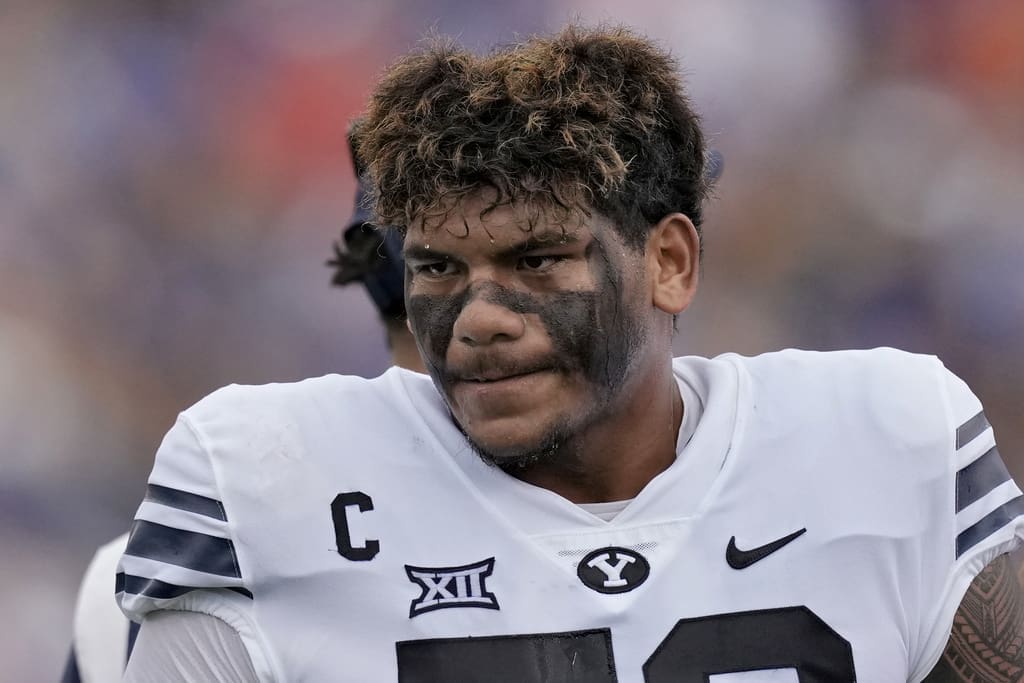 BYU offensive lineman Kingsley Suamataia cools off during a time out in the first half of an NCAA college football game against Kansas Saturday, Sept. 23, 2023, in Lawrence, Kan. (AP Photo/Charlie Riedel)