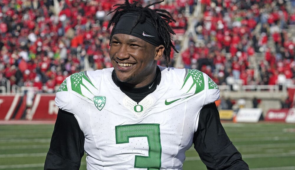 Oregon defensive end Brandon Dorlus (3) smiles on the sidelines during the second half of an NCAA college football game against Utah Saturday, Oct. 28, 2023, in Salt Lake City. (AP Photo/Rick Bowmer)