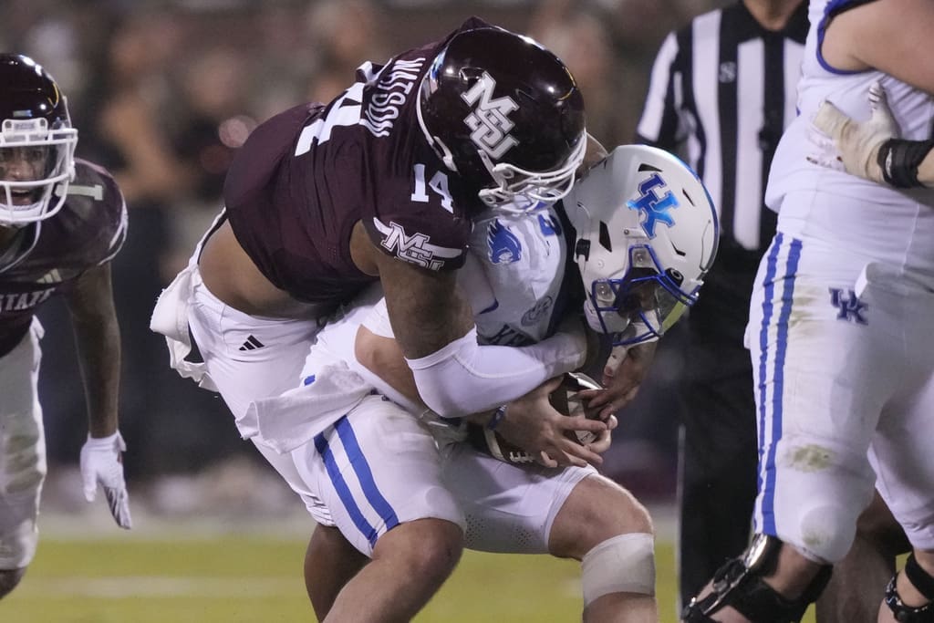 Kentucky quarterback Devin Leary (13) is sacked by Mississippi State linebacker Nathaniel Watson (14) during the second half of an NCAA college football game in Starkville, Miss., Saturday, Nov. 4, 2023. Kentucky won 24-3. (AP Photo/Rogelio V. Solis)