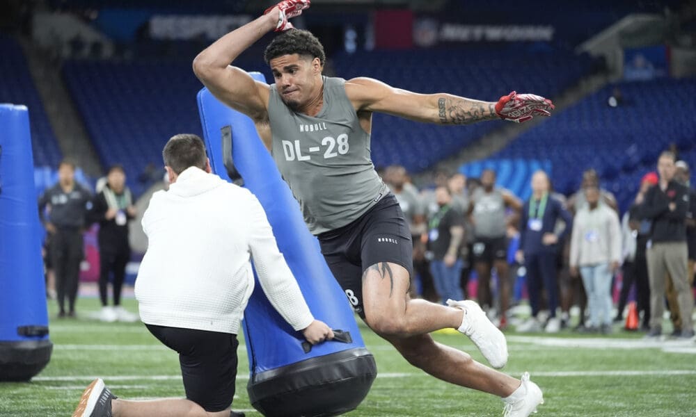 Kansas defensive lineman Austin Booker runs a drill at the NFL football scouting combine, Thursday, Feb. 29, 2024, in Indianapolis. (AP Photo/Michael Conroy)