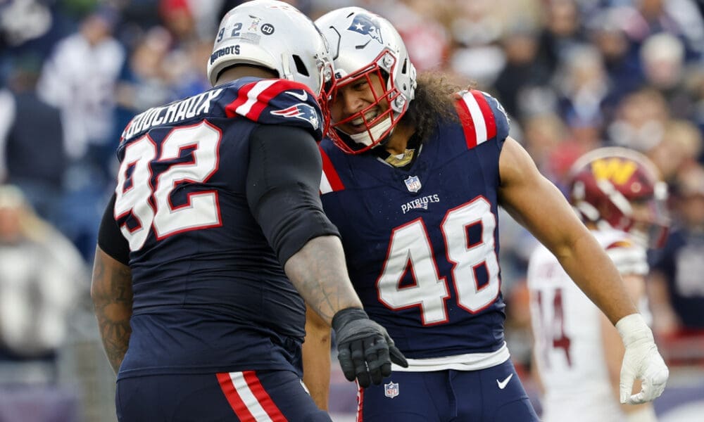 New England Patriots defensive tackle Davon Godchaux (92) celebrates with line backer Jahlani Tavai (48) after a stop during the second half an NFL football game against the Washington Commanders on Sunday, Nov. 5, 2023, in Foxborough, Mass. (AP Photo/Greg M. Cooper)