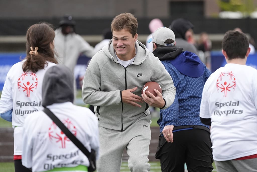 New England Patriots quarterback Drake Maye works with young athletes during an NFL Football Play Football Prospect Clinic with Special Olympics athletes, Wednesday, April 24, 2024 in Detroit. (AP Photo/Carlos Osorio)