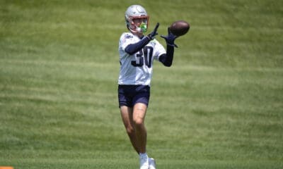 New England Patriots wide receiver David Wallis catches the ball during NFL football practice, Tuesday, June 4, 2024, in Foxborough, Mass. (AP Photo/Steven Senne)