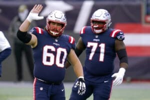 New England Patriots center David Andrews, left, and offensive lineman Mike Onwenu, right, warm up before an NFL football game against the San Francisco 49ers, Monday, Oct. 26, 2020, in Foxborough, Mass. (AP Photo/Charles Krupa)