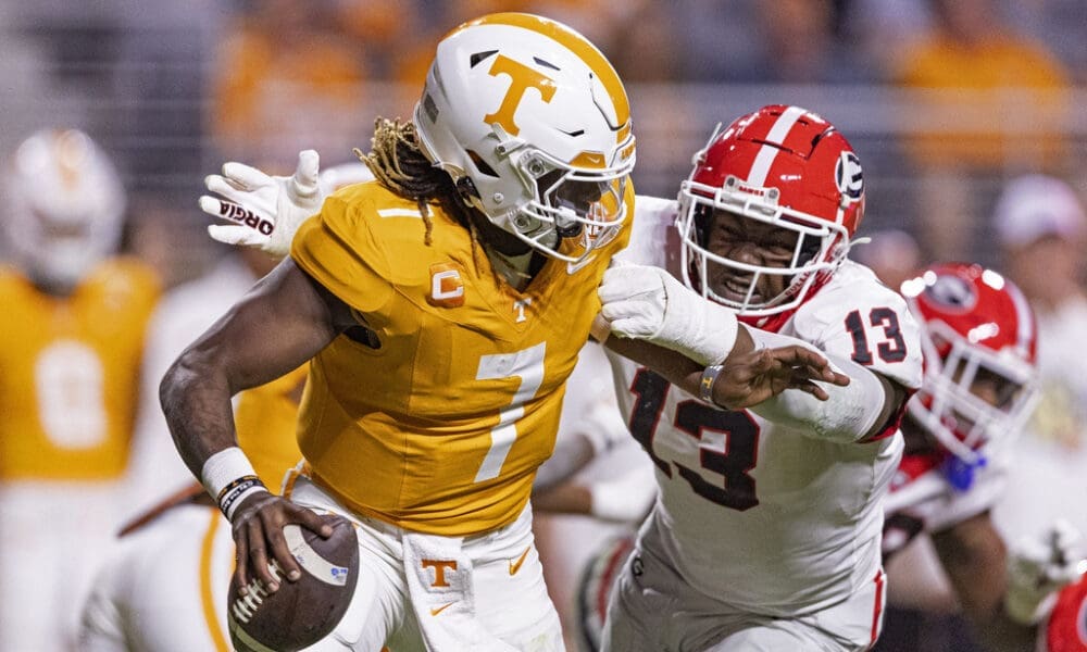 Tennessee quarterback Joe Milton III (7) is chased by Georgia defensive lineman Mykel Williams (13) during the second half of an NCAA college football game Saturday, Nov. 18, 2023, in Knoxville, Tenn. (AP Photo/Wade Payne)