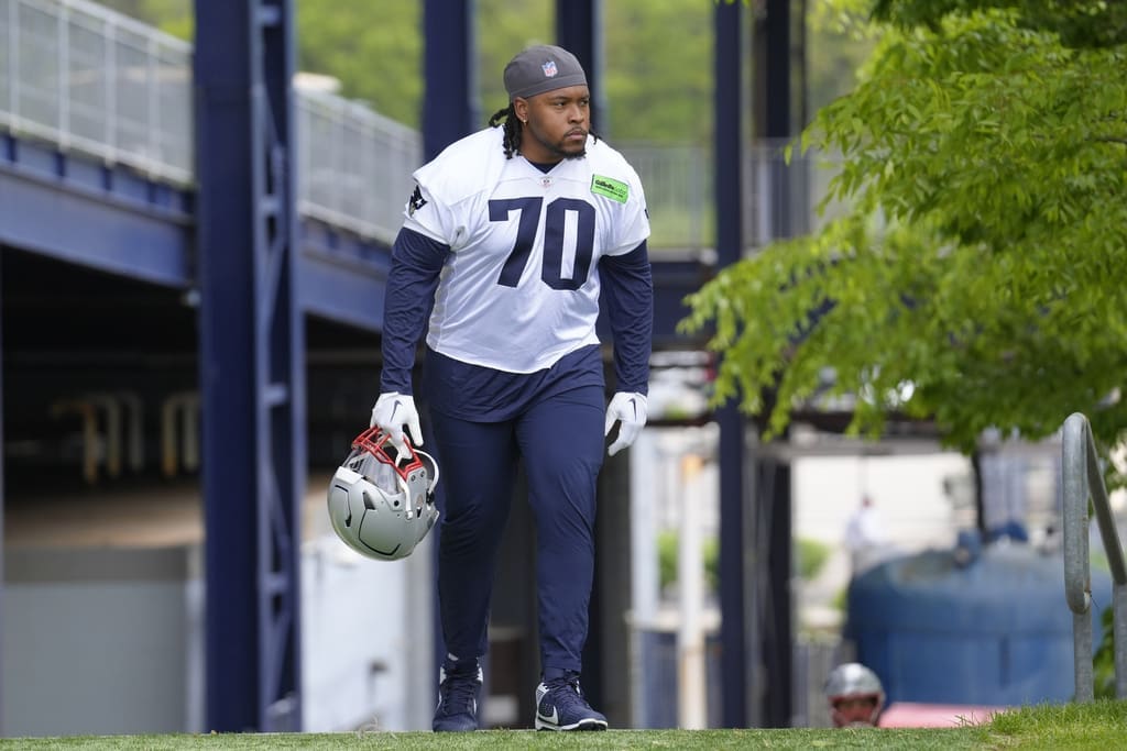 New England Patriots tackle Caedan Wallace steps on the field an NFL football practice, Monday, May 20, 2024, in Foxborough, Mass. (AP Photo/Steven Senne)