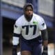 New England Patriots offensive tackle Chukwuma Okorafor (77) steps on the field for an NFL football practice, Wednesday, May 29, 2024, in Foxborough, Mass. (AP Photo/Steven Senne)