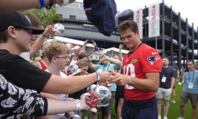 New England Patriots quarterback Drake Maye (10), center right, signs autographs for fans following an NFL football training camp, Wednesday, July 24, 2024, in Foxborough, Mass. (AP Photo/Steven Senne)