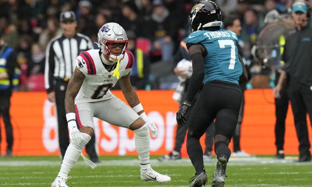 New England Patriots cornerback Christian Gonzalez (0) in coverage against Jacksonville Jaguars wide receiver Brian Thomas Jr. (7) during an NFL football game at Wembley Stadium, Sunday, Oct. 20, 2024, in London. (AP Photo/Steve Luciano)