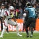 New England Patriots cornerback Christian Gonzalez (0) in coverage against Jacksonville Jaguars wide receiver Brian Thomas Jr. (7) during an NFL football game at Wembley Stadium, Sunday, Oct. 20, 2024, in London. (AP Photo/Steve Luciano)