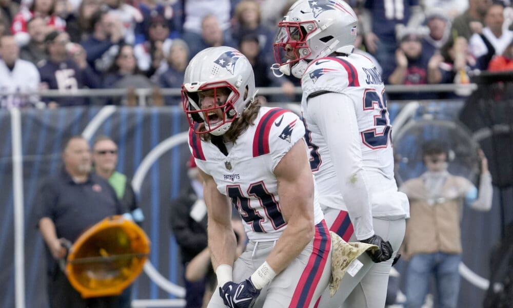 New England Patriots safety Brenden Schooler (41) celebrates his sack of Chicago Bears quarterback Caleb Williams with Anfernee Jennings during the second half of an NFL football game Sunday, Nov. 10, 2024, in Chicago. (AP Photo/Nam Y. Huh)