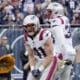 New England Patriots safety Brenden Schooler (41) celebrates his sack of Chicago Bears quarterback Caleb Williams with Anfernee Jennings during the second half of an NFL football game Sunday, Nov. 10, 2024, in Chicago. (AP Photo/Nam Y. Huh)