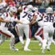 New England Patriots quarterback Drake Maye (10) passes the ball to running back Rhamondre Stevenson (38) during the first half of an NFL football game against the Chicago Bears, Sunday, Nov. 10, 2024, in Chicago. The Patriots defeated the Bears 19-3. (AP Photo/Kamil Krzaczynski)