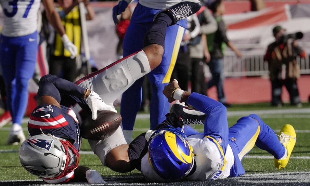 New England Patriots wide receiver Kendrick Bourne, left, lands in the end zone for a touchdown against Los Angeles Rams cornerback Ahkello Witherspoon during the first half of an NFL football game, Sunday, Nov. 17, 2024, in Foxborough, Mass. (AP Photo/Steven Senne)