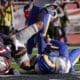 New England Patriots wide receiver Kendrick Bourne, left, lands in the end zone for a touchdown against Los Angeles Rams cornerback Ahkello Witherspoon during the first half of an NFL football game, Sunday, Nov. 17, 2024, in Foxborough, Mass. (AP Photo/Steven Senne)